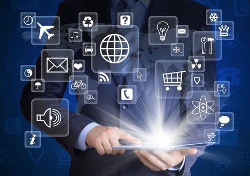 Man in suit holding tablet pc and application icons in hand. The concept of software