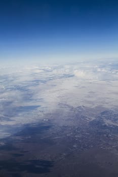 Arial view of the western USA, seeing snow covered land going to desert condition 