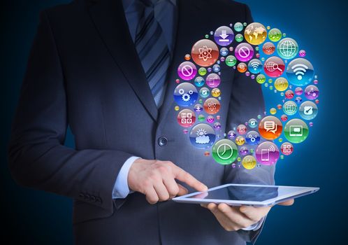 Businessman in a suit holding a tablet in his hands. Above the screen tablet application icons in the form of play button