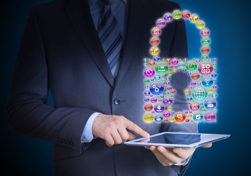 Businessman in a suit holding a tablet in his hands. Above the screen tablet application icons in the form of padlock