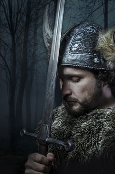 Peace, Viking warrior, male dressed in Barbarian style with sword, bearded