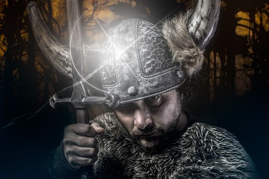 War, Viking warrior, male dressed in Barbarian style with sword, bearded