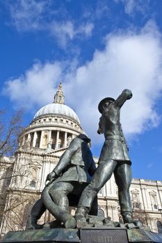 The National Firefighters Memorial in the City of London with St. Paul's Cathedral in the background.
