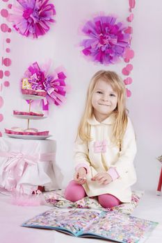 Smiling girl having fun at pink decirated birthday party