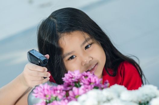 asia  girl with a shy smile and a pretty flower.