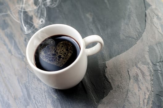 cup coffee with heart symbol on a stone table  background 