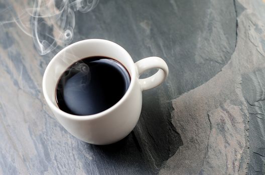 Cup of fresh coffee  on stone table