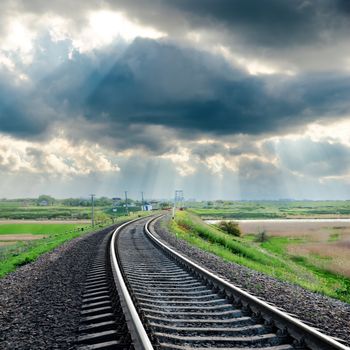 railroad and rainy clouds over it