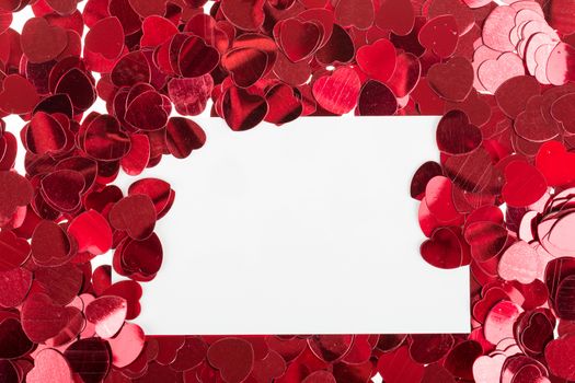 small red confetti and emty card for valentine love message