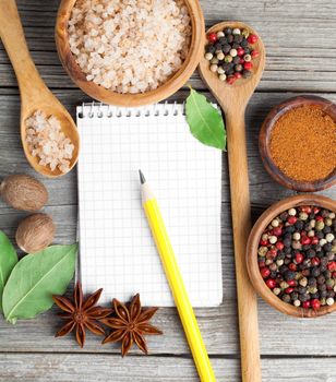 top view of recipe book with ingredients on wooden table