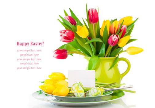 Easter eggs and blank for text in a plate, with tulips flowers on a white background