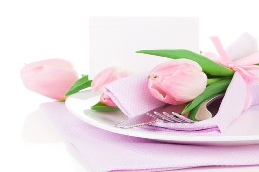 Romantic dinner / table setting with roses tulips and cutlery, with and blank for text on a white background. Copy space.