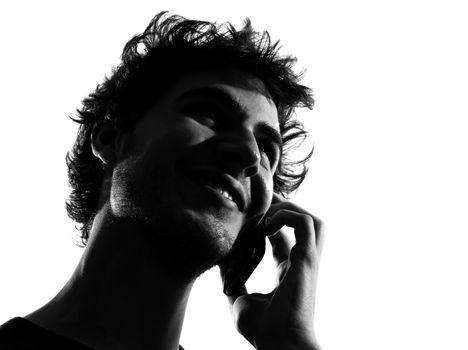 young man looking up telephone smiling portrait silhouette in studio isolated on white background