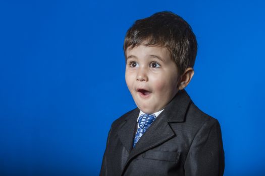 Leader, cute little boy portrait over blue chroma background