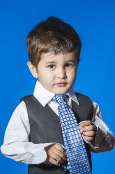 Leader, cute little boy portrait over blue chroma background