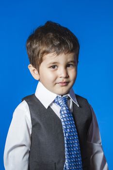 Leader, cute little boy portrait over blue chroma background