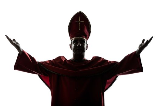 one man cardinal bishop silhouette saluting blessing in studio isolated on white background