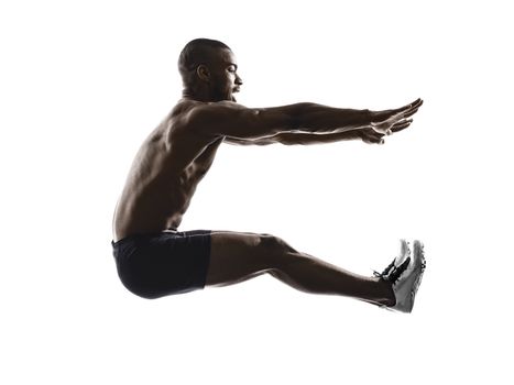 one young african muscular build man long jumping silhouette  isolated on white background