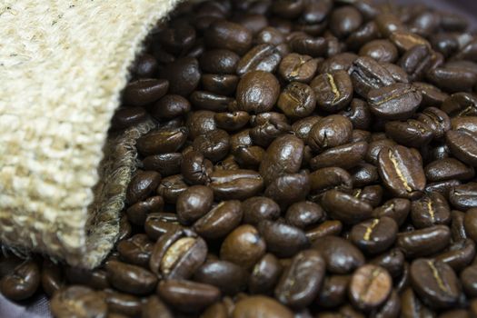 Detail of coffee beans outside his jute bag