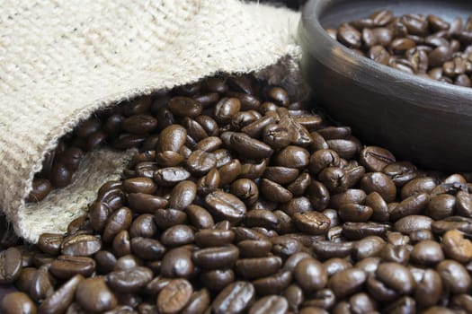 Detail of coffee beans, small clay pot and jute bag