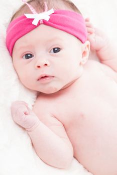 happy newborn baby girl just a week old photographed in the studio