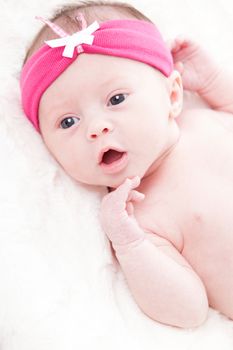 happy newborn baby girl just a week old photographed in the studio