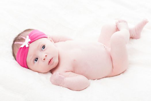 happy newborn baby girl just a week old photographed in the studio