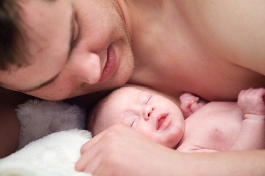 happy newborn baby girl just a week old photographed in the studio