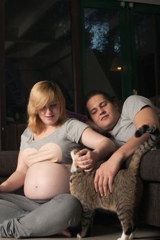 Young couple is waiting for their first child in the living room