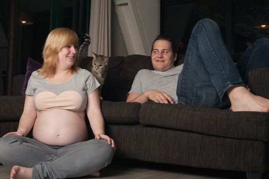 Young couple is waiting for their first child in the living room