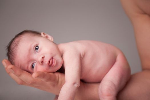 happy newborn baby girl just a week old photographed in the studio