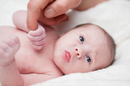 happy newborn baby girl just a week old photographed in the studio