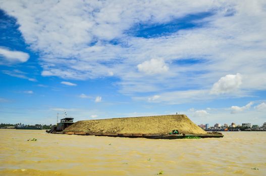 A woman with palm leaf conical hat rowing at Tra Su Natural Reserve in Mekong Delta, An Giang, Vietnam