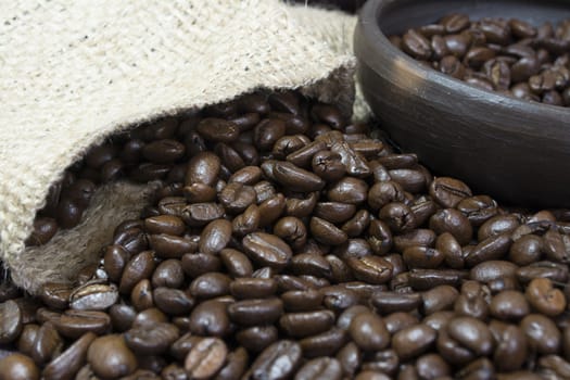 Detail of coffee beans, small clay pot and jute bag.
