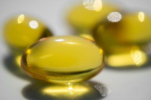 Macro to a yellow pills with a blue background.