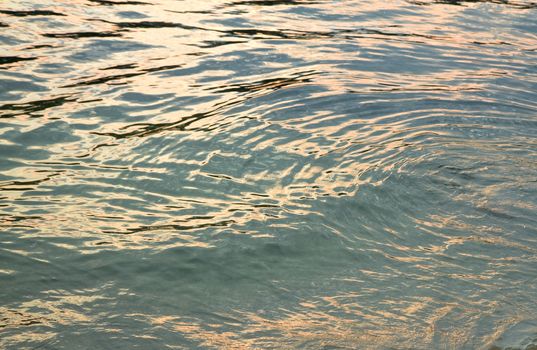 Colorful Sunset reflections on water surface