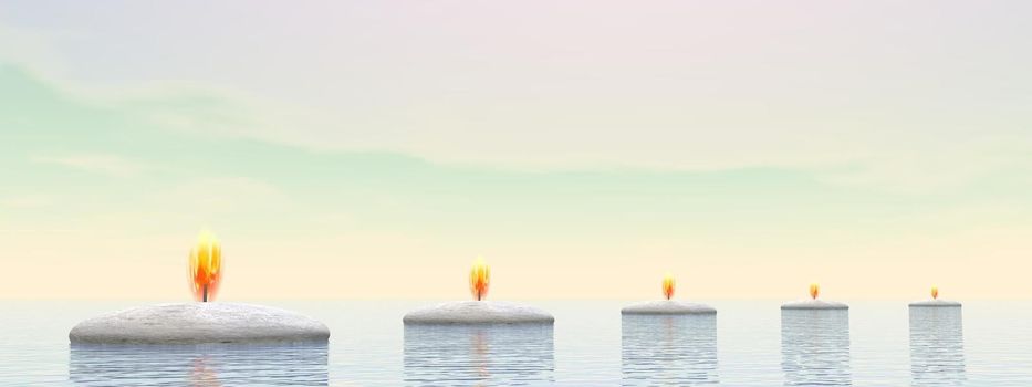 Stones with fire lights as steps on the ocean by day time