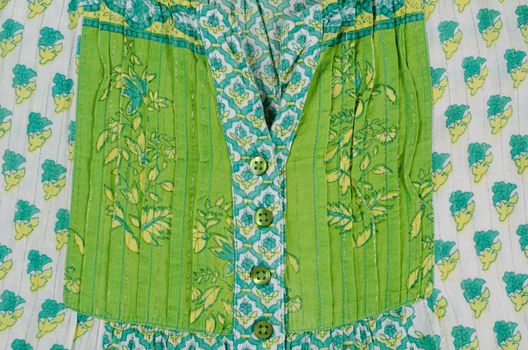 Detail take of a  patterned green blouse