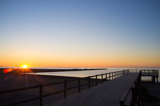 Wooden jetty   on the Mediterranean during sunrise