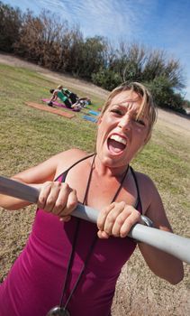 Loud boot camp fitness instructor with outdoor class