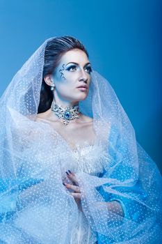 Attractive girl with scenic makeup in the image snow queen