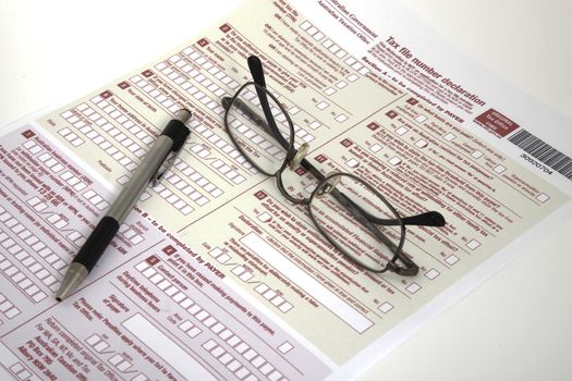 Tax declaration, pen and glasses