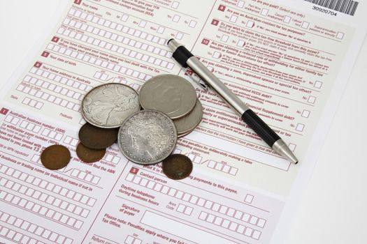 Tax declkaration on the desk with pen and coins