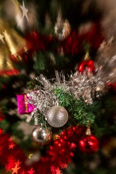 Christmas tree decoration with, lights, garland, tinsel and christmas ball