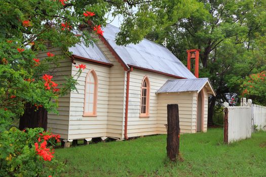 Little country church with outdoor bell, arched windows and portico  St Andrews Built 1927.