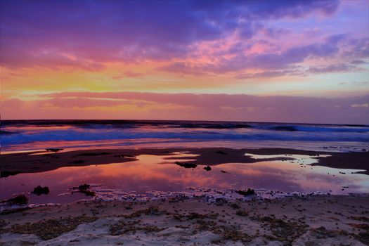 Red dawn at The Entrance, the sky bursts into rich firery colours.  NSW Australia.