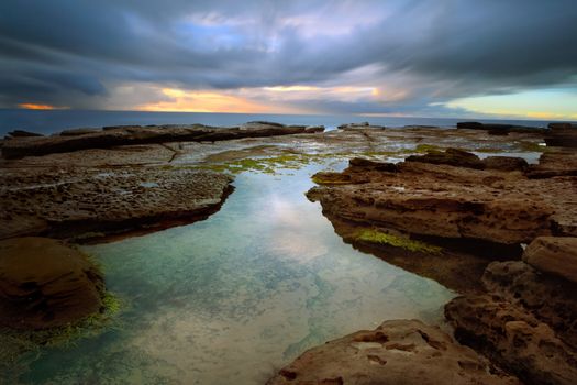 Stormy sunrise and rain over Little Bay, Central Coast, NSW Australia