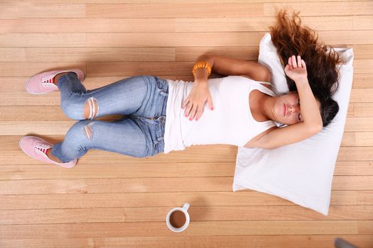 A young Girl relaxing with some Coffee at home.