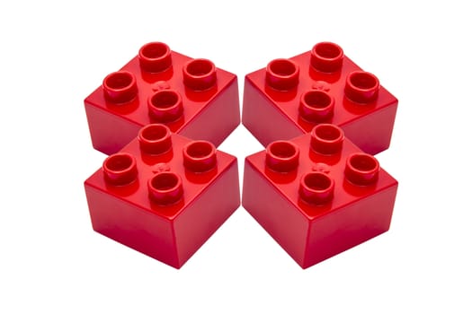 Red building blocks closeup on white background 