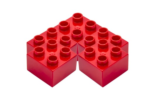 Red building blocks closeup on white background 